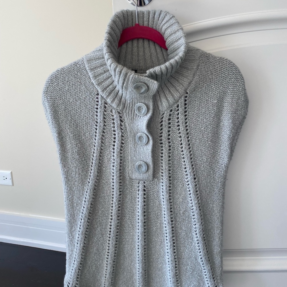 Gorgeous BCBG knitwear.Capped sleeve, highneck button top, flattering stitching